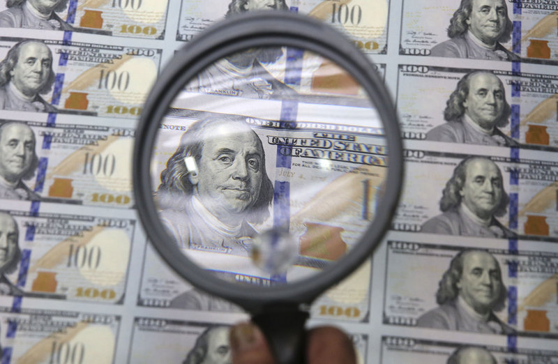 A sheet of uncut $100s gets a quick inspection at the Bureau of Engraving and Printing Western Currency Facility in Fort Worth, Texas, on Tuesday.
