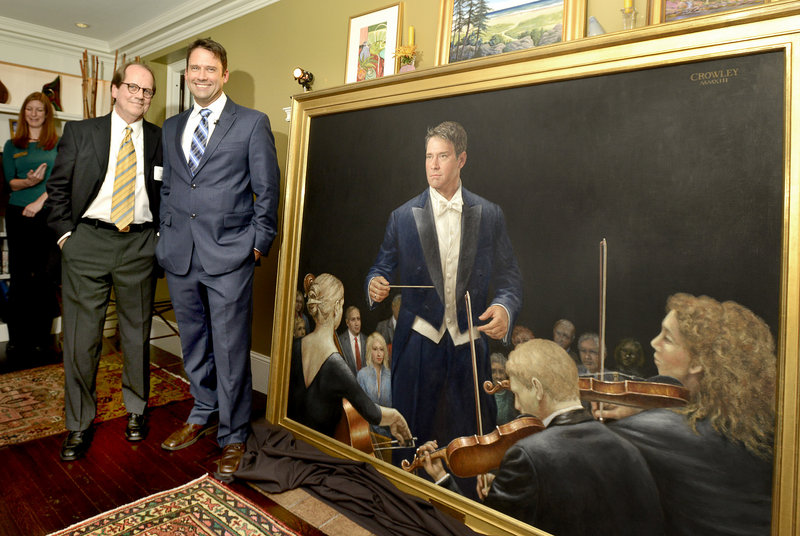 Artist James Crowley and Portland Symphony conductor Robert Moody stand next to a 54" x 66" oil on canvas portrait of Moody painted by Crowley at a unveiling in Portland on Wednesday, Sept. 25, 2013.