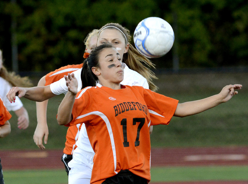 Peyton Janelle of Biddeford keeps her hands away from the ball and prepares to send it forward while taking control in front of Amanda Arnold of Thornton Academy.
