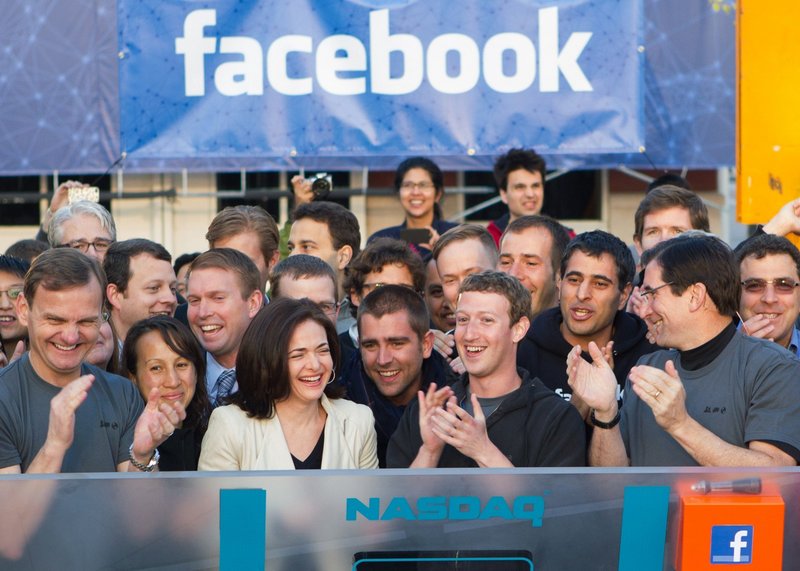Facebook founder Mark Zuckerberg, center, applauds during the company’s IPO last year. The stock has more than recovered early losses, approaching $50 after falling to $17.55.
