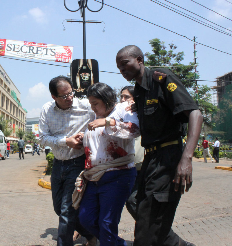 A security officer helps a wounded woman Saturday outside a mall in Nairobi, Kenya, during an attack that left dozens of people dead. A reader criticizes the “overhyping” of allegations that a Somali-American Mainer was involved in the raid.