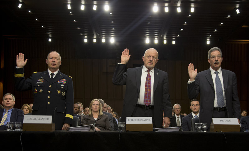 From left, NSA Director General Keith Alexander, Director of National Intelligence James Clapper and Deputy Attorney General James Cole are sworn before a hearing Thursday.