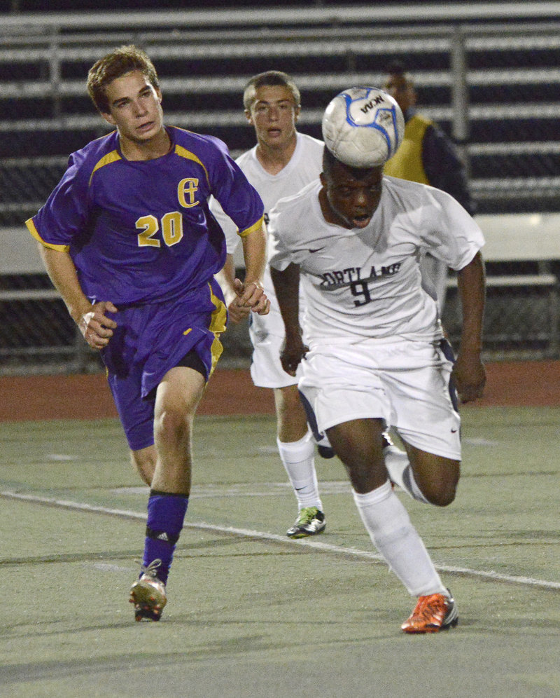 Yusef Yama of Portland heads the ball up the field Thursday while being chased by Alex Nason of Cheverus during their SMAA game at Fitzpatrick Stadium. Yama scored the tying goal after Nason opened the scoring in a 1-1 game.