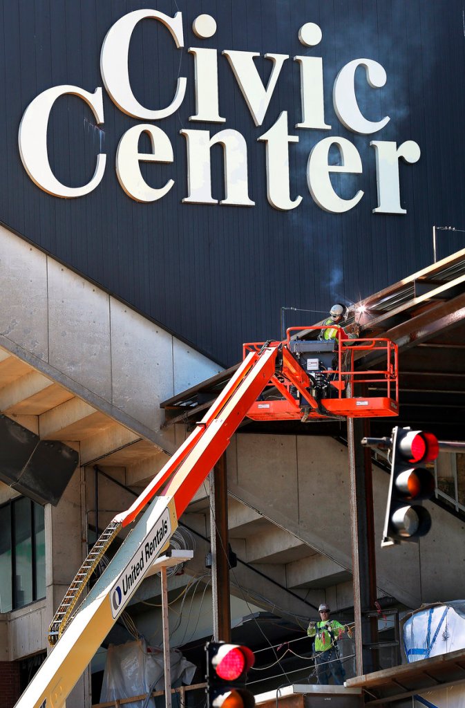 A welder works on the exterior of the Cumberland County Civic Center on Friday. The Portland Pirates’ departure leaves the civic center without an anchor tenant.
