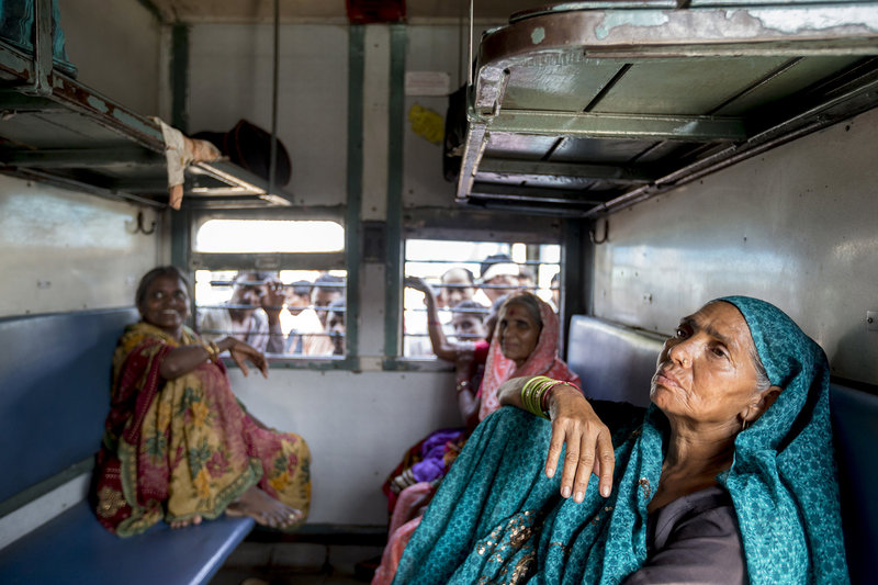 Sondi (no last name given, at right) rides with friends in a women-only train car in New Delhi, India. After a brutal gang rape spotlighted violence against women, many crave safety.