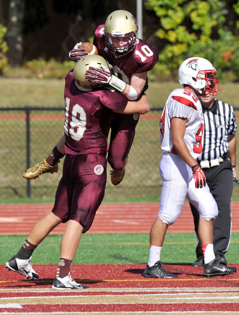 Carter Davis of Thornton Academy receives a lift from Cody Lynn after catching a touchdown pass in the second quarter of a 25-9 victory against Sanford on Saturday.