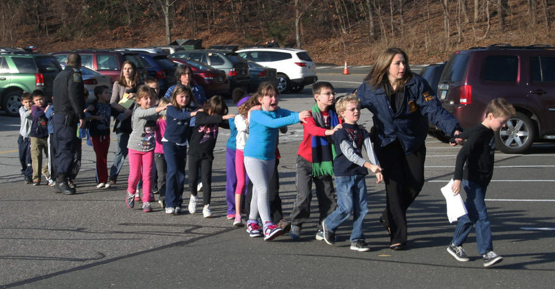 State police lead a line of children from the Sandy Hook Elementary School in Newtown, Conn., after a shooting at the school last Dec. 14. Hundreds of schoolchildren survived, but the horrors have been especially difficult to overcome for some of the 6- and 7-year-olds who witnessed the bloodbath.
