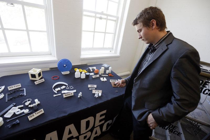 Aaron Kemmer, CEO and co-founder of Made In Space, in Mountain View, Calif., on Sept. 16, looks at items useful in outer space that were made with the company’s 3-D printer.