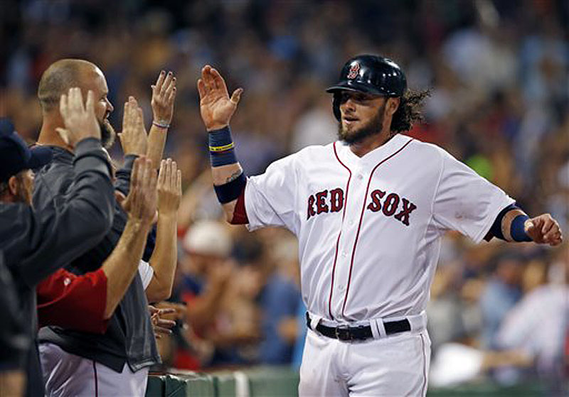 Boston's Jarrod Saltalamacchia , right, receives high-fives after scoring the winning run on Aug. 28 in a game against the Baltimore Orioles at Fenway Park. With catcher Jason Varitek now in his second year of retirement, Saltalamacchia is the new leader.