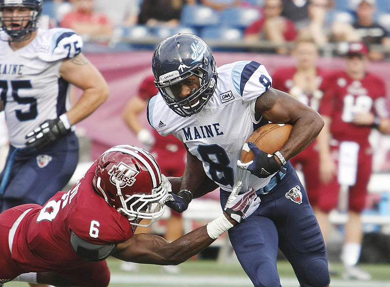 Derrick Johnson tries to break a tackle by Ed Saint-Vil of UMass after one of his five receptions.