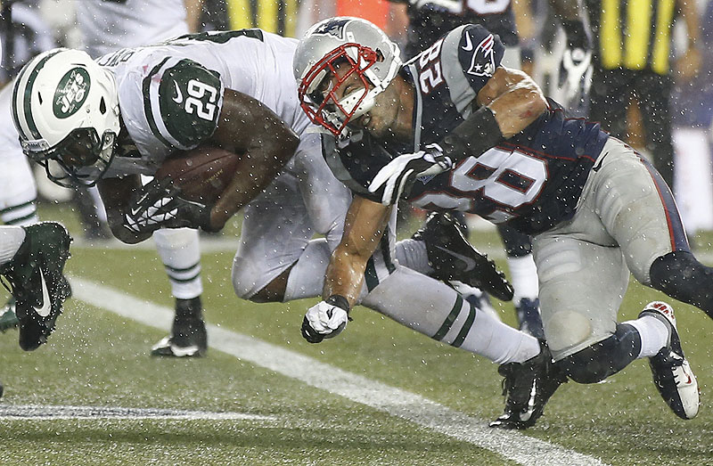 New York running back Bilal Powell scores a touchdown despite the efforts of New England strong safety Steve Gregory in Foxborough on Thursday night. NFLACTION13;