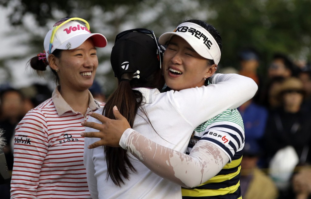 Amy Yang of South Korea, right, is congratulated by Danielle Kang of the United States, center, and Chella Choi of South Korea after winning the KEB Hana Bank Championship golf tournament at Sky72 Golf Club in Incheon, west of Seoul, South Korea on Sunday.