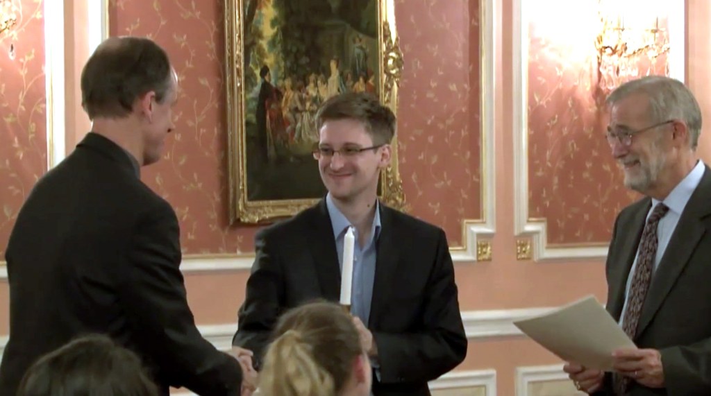 In this image made from video released by WikiLeaks on Oct. 11, 2013, former National Security Agency systems analyst Edward Snowden, center, receives the Sam Adams Award in Moscow, Russia. AP Photo