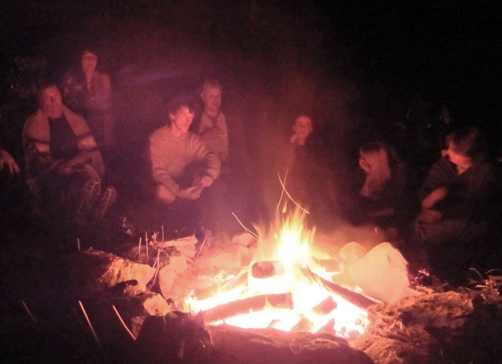 The fire glows at a gathering of druids.