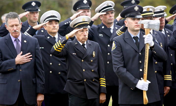 Members of the Portland Fire Department salute during the reading of those who died in the line of duty during the Portland Veteran Firemen’s Association memorial service Sunday in South Portland.