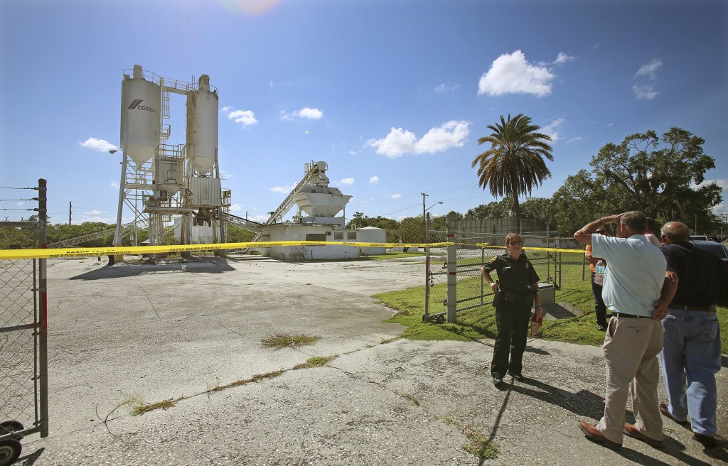 The Associated Press FILE - In this Sept. 10, 2013 file photo, Polk County Sheriff personnel investigate the death of 12-year-old girl, Rebecca Ann Sedwick, at an old cement plant in Lakeland, Fla. Two girls have been arrested in her death. Officials say she committed suicide after being bullied online for nearly a year. On Tuesday, Oct. 15, 2013 Polk County Sheriff Grady Judd will announce charges against the girls, age 12 and 14, in a press conference.
