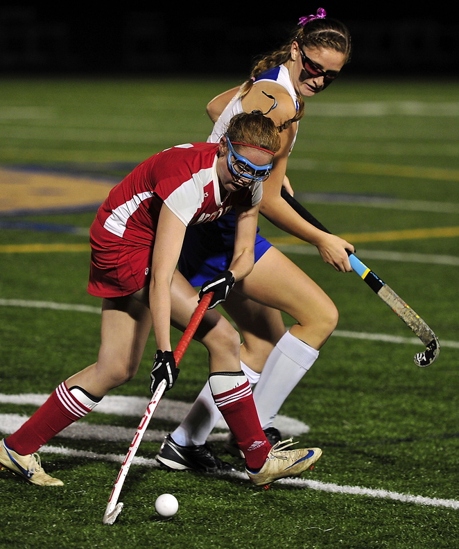 Elizabeth Helmreich of Sanford looks for a way around Leika Scott of Falmouth during their Western Class A field hockey quarterfinal Wednesday night. Falmouth won 4-0 and will be at Massabesic in the semifinals.
