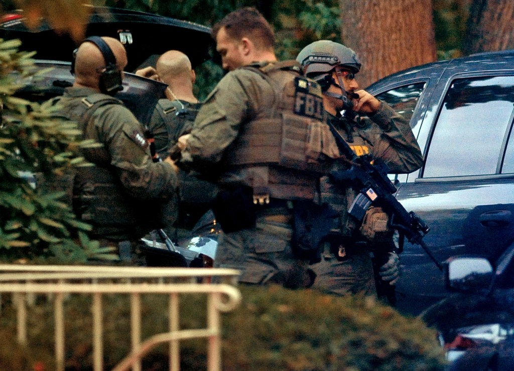 Members of the FBI suit up outside the residence of Miriam Carey in Stamford, Conn. Thursday, Oct. 3, 2013. Law-enforcement authorities have identified Carey, 34, as the woman who, with a 1-year-old child in her car, led Secret Service and police on a harrowing chase in Washington from the White House past the Capitol Thursday, attempting to penetrate the security barriers at both national landmarks before she was shot to death, police said. The child survived.