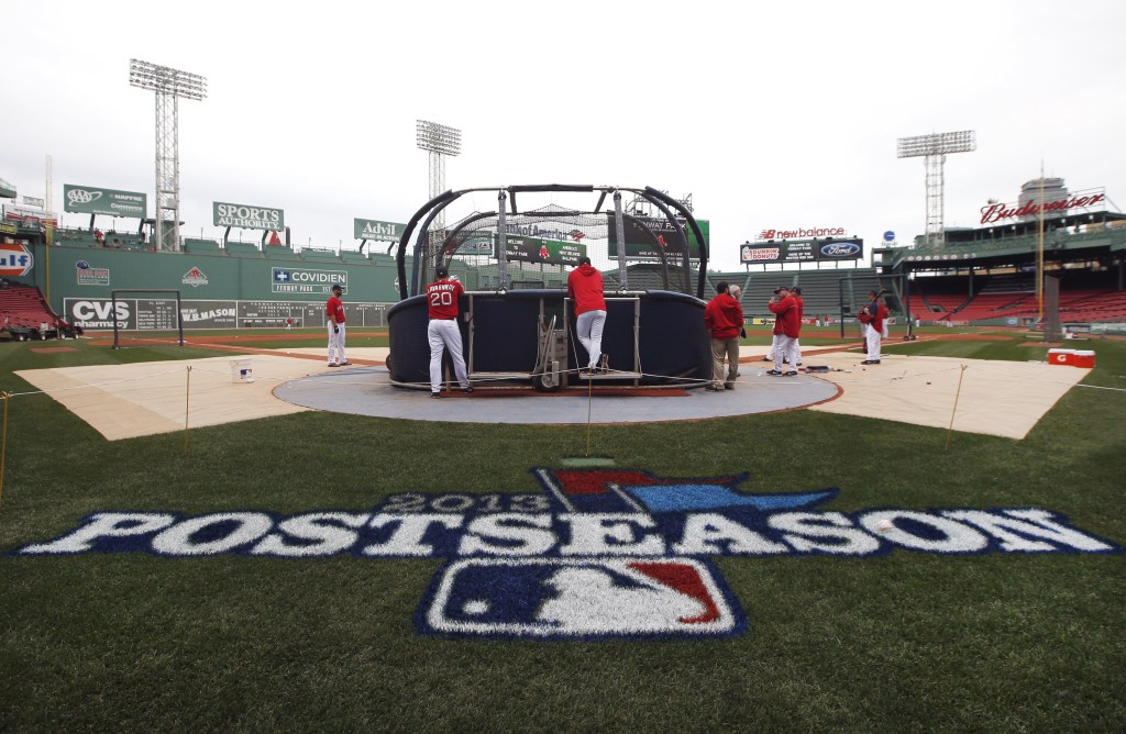 Boston Red Sox baseball players gather around the batting cage during a workout at Fenway Park in Boston on Thursday in preparation for Game 1 of the AL championship series against Detroit on Saturday.