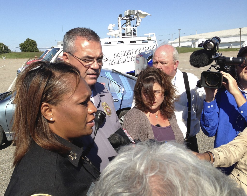 Police Chief Rita Stanback and Fire Chief Gary Graves, second from left, of Millington, Tenn., brief reporters about a shooting near a U.S. Naval Support Activity Mid-South on Thursday. The Navy said two soldiers were wounded, though neither had life-threatening injuries.