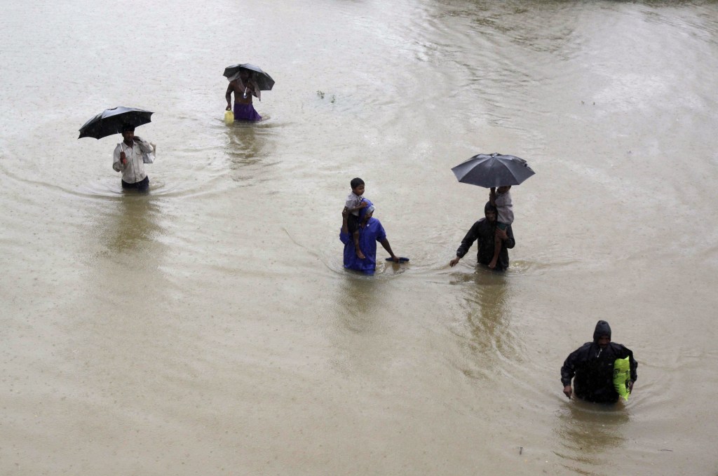 Villagers wade through floodwaters to reach safer areas in Khurda district in the eastern Indian state of Orissa on Friday. More than 70,000 people have been evacuated.