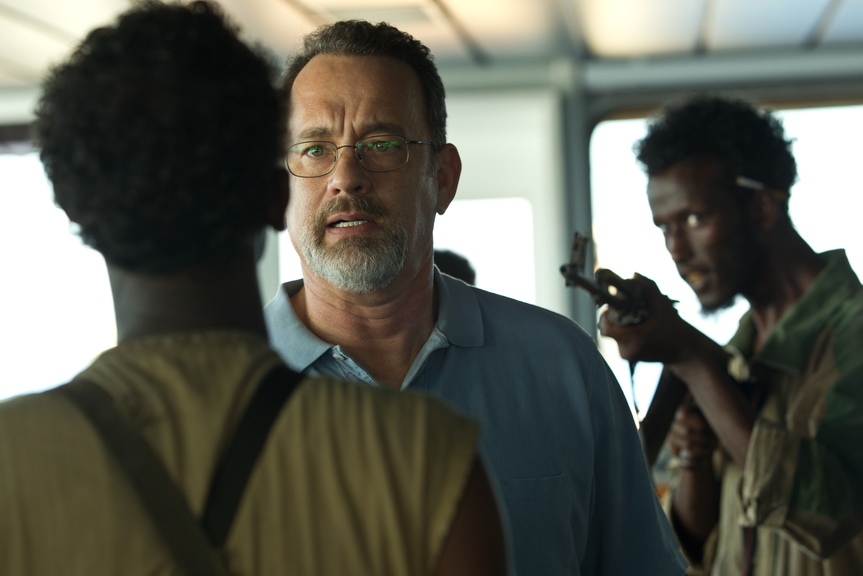 Tom Hanks, center, deals with pirates in “Captain Phillips,” a film dramatizing the 2009 attack on the M.V. Maersk Alabama off the coast of Africa. Directed by Paul Greengrass, the movie is good enough to keep viewers on the edge of their seats to the end even though they probably already know how it turns out.