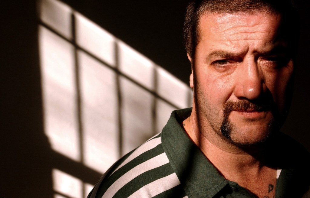 Mark “Chopper” Read is shown in Sydney, Australia, in June 2002. The notorious criminal detailed his career in the book, “How to Shoot Friends and Influence People.”