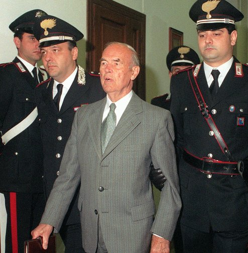 Former German SS officer Erich Priebke enters a military court in Rome in 1996. He eventually was sentenced to life in prison for his role in World War II atrocities. Because of his age, he served his term under house arrest. He died Friday.