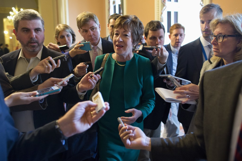 Sen. Susan Collins, R-Maine, talks with reporters after arriving on Capitol Hill in Washington on Friday following a meeting between Republican senators and President Obama at the White House on the ongoing budget battle.