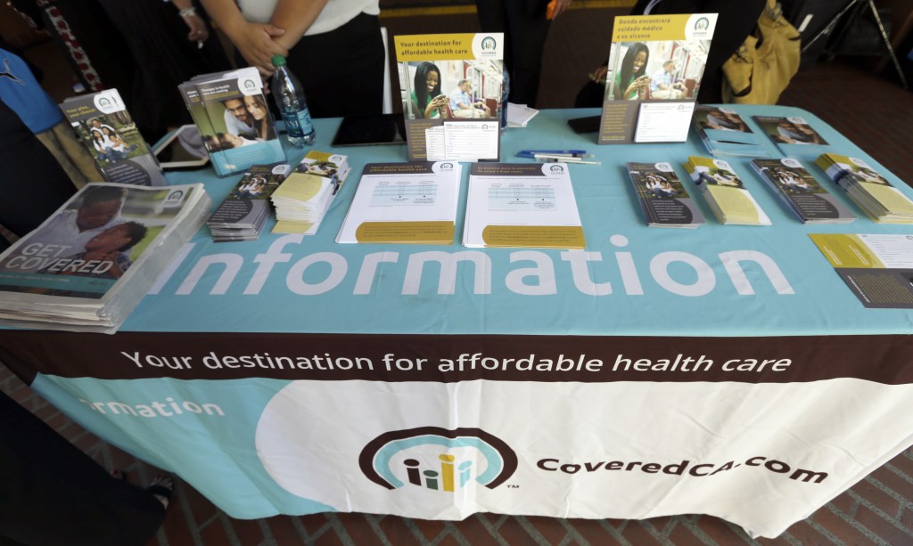 An information table is seen at Union Station in downtown Los Angeles as people seek information on state-provided health insurance, while a celebration is underway to inaugurate the first day people can enroll Tuesday, Oct. 1, 2013. Californians who buy their own health insurance and those who have been hoping for coverage began using the state’s online marketplace Tuesday after it opened for business on the first day of enrollment.