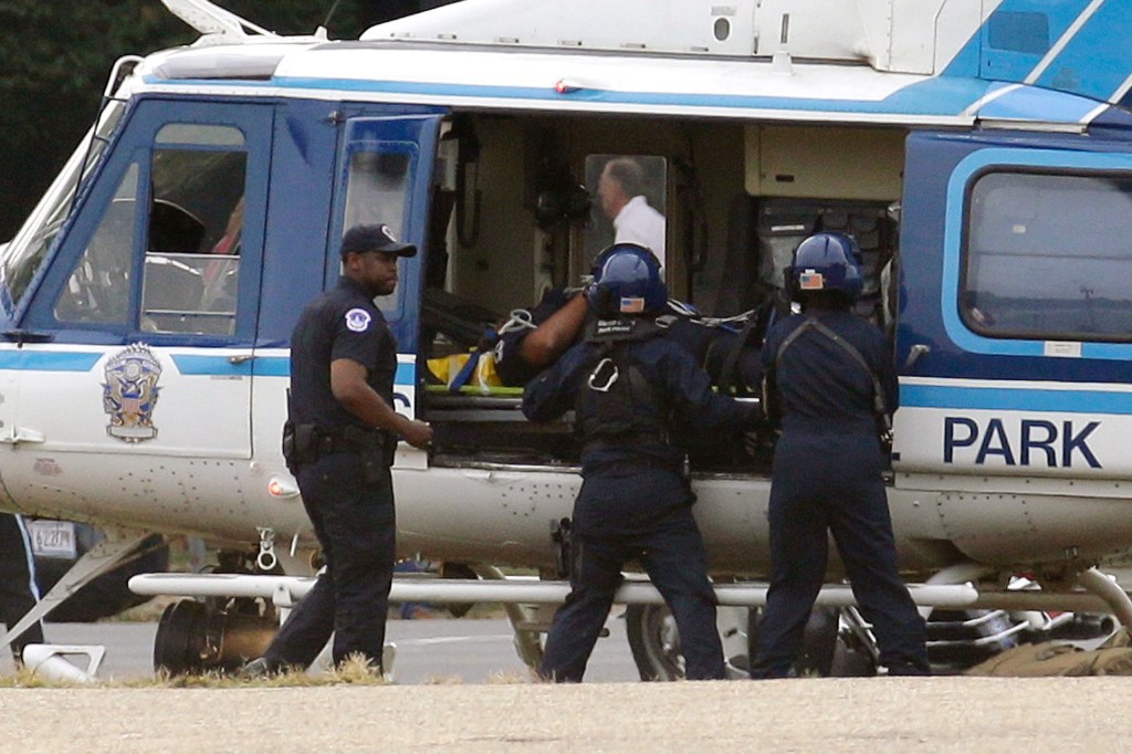 A U.S. Park Police helicopter is loaded with an injured police officer on the Mall in Washington on Thursday.