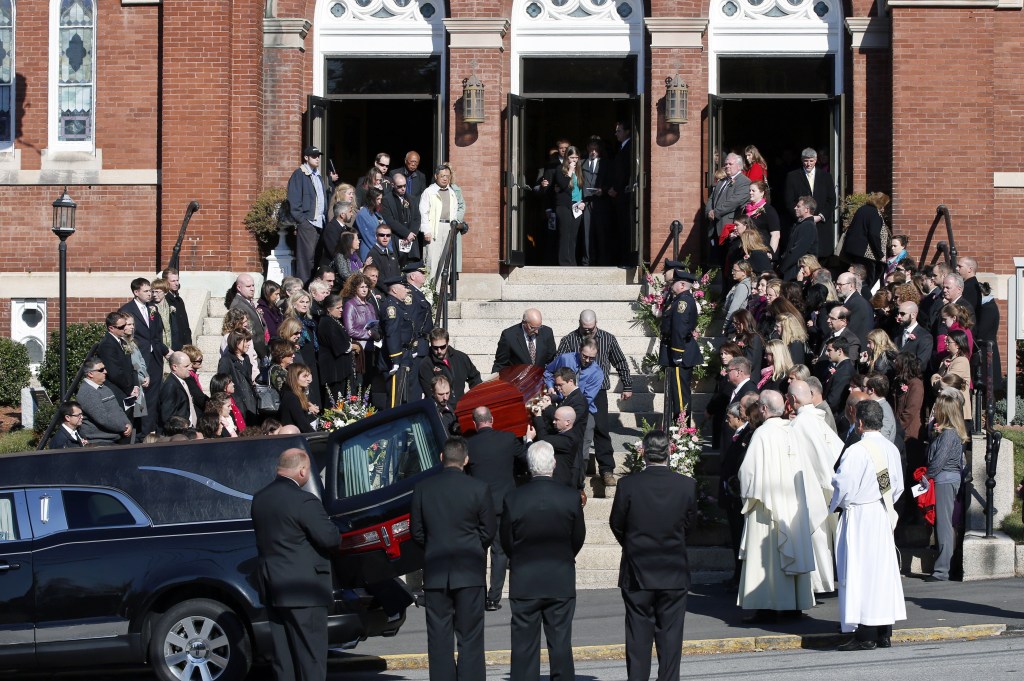 Mourners line the steps of St. Augustine Church in Andover, Mass., Monday as the casket of slain Danvers High School teacher Colleen Ritzer is carried out from her funeral Mass into a hearse.