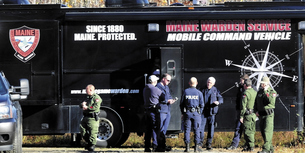 Officers from various agencies confer outside the Maine Warden Service Mobile Command Vehicle parked on Nike Lane in Oakland as officers searched the woods for signs of missing toddler Ayla Reynolds on Wednesday morning.
