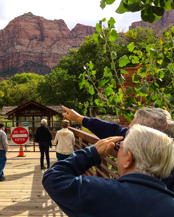 Tourists point out landmarks visible from the gate to Zion National Park in Utah, which is closed because of the federal shutdown.