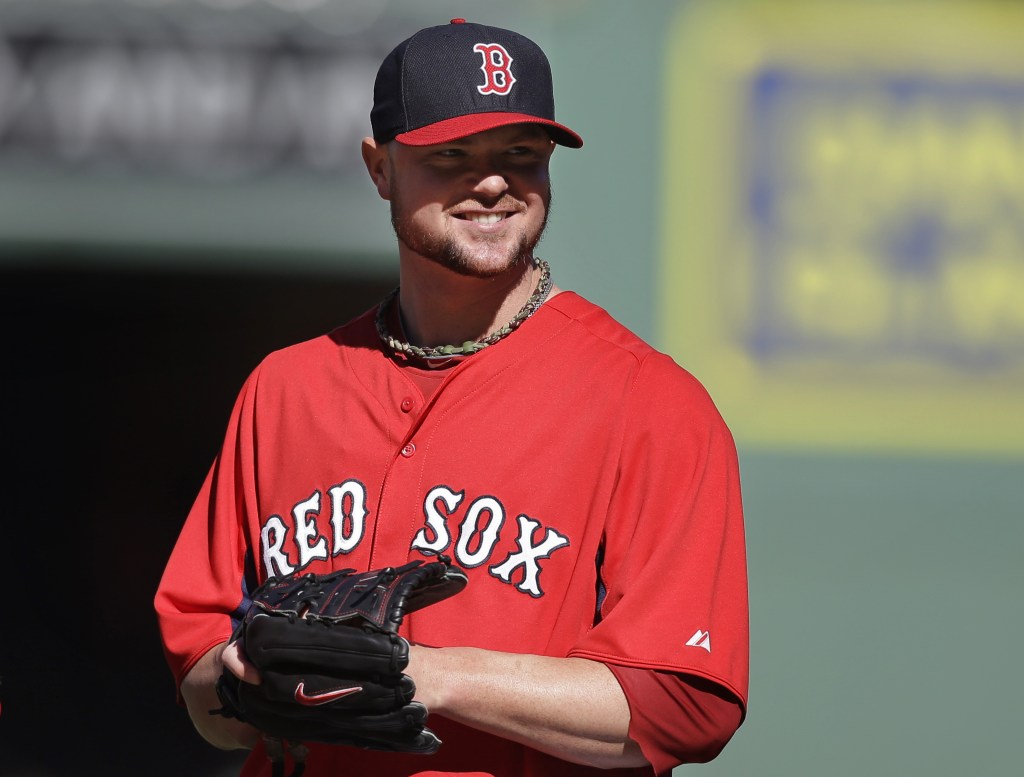 Boston Red Sox pitcher Jon Lester smiles during a team workout Tuesday, Oct. 1, 2013, at Fenway Park in Boston.