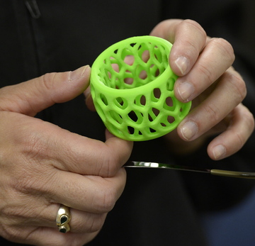 Consultant Sarah Boisvert, an expert on 3D printing, shows a napkin ring she made with a 3D printer.