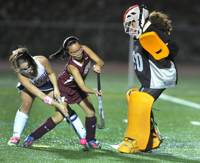 Lily Daggett of Yarmouth, left, attempts to get the rebounded ball past Lee Brown of Freeport and goalie Morgan Karnes. Karnes also stopped this attempt. Yarmouth moved to 9-4-1. Freeport is 5-9.