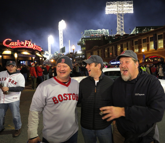 Friends Adam Taylor of Falmouth, Jay Cross of Cape Elizabeth and Dan Lay of Brunswick mingle on Brookline Avenue outside of Fenway Park before Game 6. The Mainers said they came to see history, shorten their bucket lists and simply have a good time.