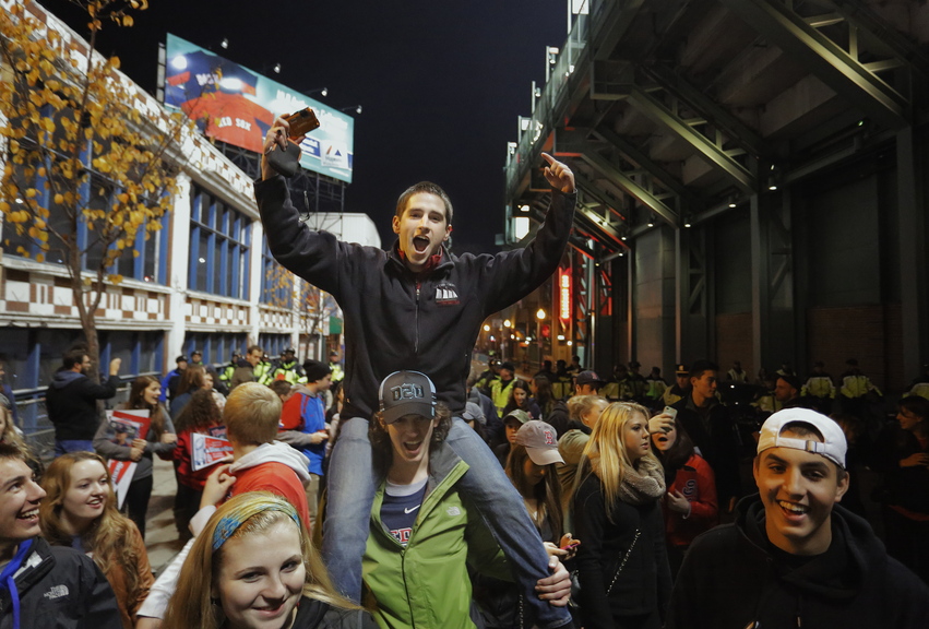 Gabe Souza/Staff Photographer Ben Eley of Blue Hill in Maine, now a college student in Boston, celebrates on the shoulders of a friend outside Fenway Park as the Red Sox built a lead early in Game 6.