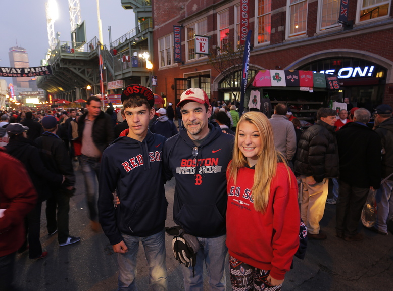 Gabe Souza/Staff Photographer Lance Richmond of Pittsfield stands with his 14-year-old twins, Carter and Emily, on Landsdowne Street outside Fenway Park before the start of Game 6. “We’re all in,” Richmond said. “The Red Sox are winning it tonight. We don’t have tickets for Game 7.”