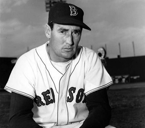 Ted Williams of the Boston Red Sox poses at Fenway Park in Boston. That pointy, ornate “B” on the Red Sox cap endures today.