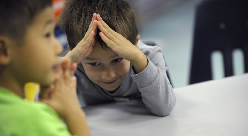 Tommy Henp, 5, left, and Preston Kirkendall, 5, learn sign language during a lesson at a homeschooling co-operative at Andrews Air Force Base, Md.