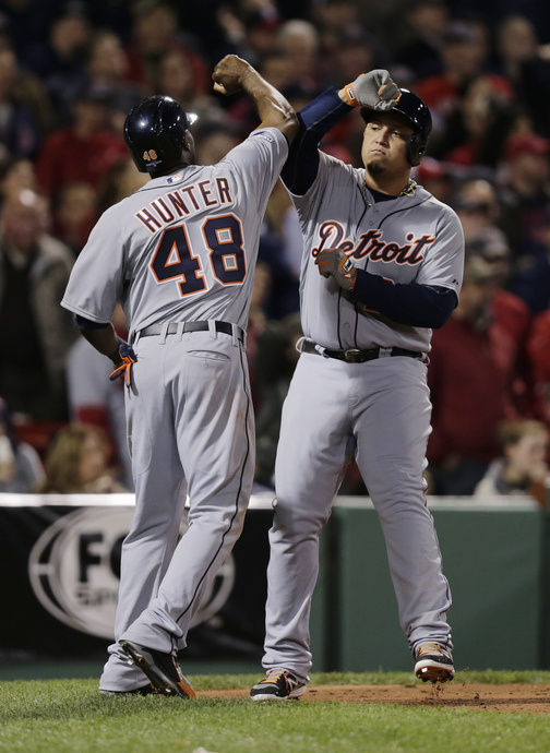 Detroit Tigers' Torii Hunter (48) and Miguel Cabrera celebrate after they both scored against the Boston Red Sox inning during Game 6 of the American League baseball championship series on Saturday, Oct. 19, 2013, in Boston.. (AP Photo/Charles Krupa)