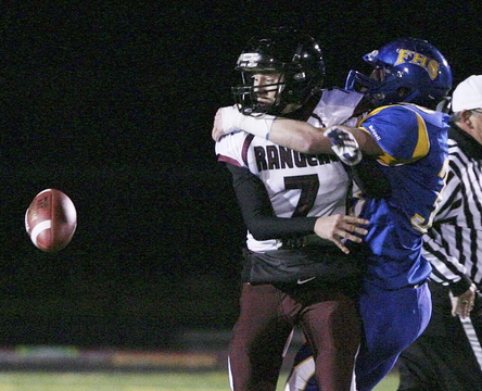 Greely's Matt Pisini, left, watches as he fumbles after being hit by Falmouth High School's Tyler Rolfe Friday night.