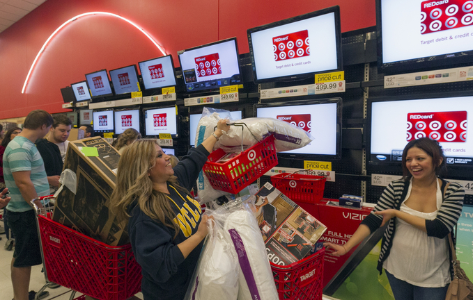 Shopper Roxanna Garcia, center, waits in line to pay for more than $1,000 in gifts at the Target store in Burbank, Calif., last year. Now that the U.S. has averted a default on its debt that could have sent the economy into a tailspin, retailers hope shoppers forget the plan offers only a short reprieve until early next year.
