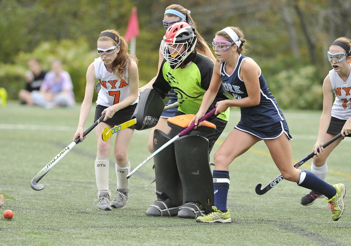 York’s Taylor Simpson (right), moves in for a rebound after a defensive effort by NYA goalie Elizabeth Coughlin and teammate Charlotte Eisenberg (left) during York’s 4-0 win on Tuesday. York is now 14-0: NYA falls to 11-2-1.