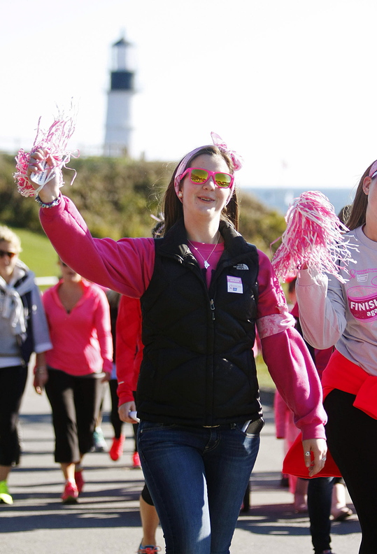 Jill Brady/Staff Photographer Chelsey Oliver of Sydney walks with her friend, Danielle Fossett, right, of Cumberland with their team "For the Love of Beryl," in honor of Danielle's mother, Beryl Fossett, who is a 4-year survivor of breast cancer Sunday, October 20, 2013 during the American Cancer Society walk to support the fight against breast cancer at Fort Williams Park in Cape Elizabeth.