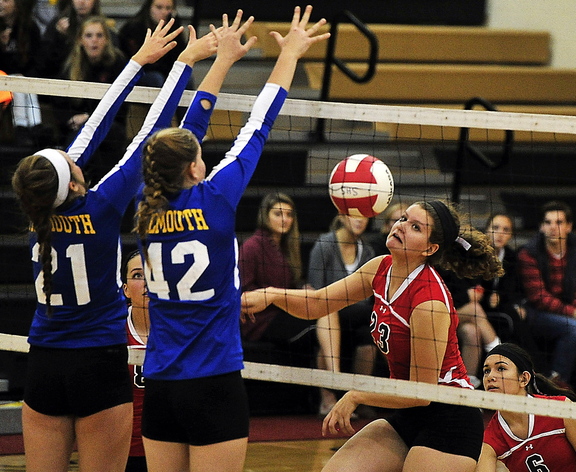Katrina Meserve, left, and Julia Treadwell of Falmouth team up to block Scarborough’s Mary Cleary. Falmouth’s only losses this season have been against Scarborough – both in five sets.