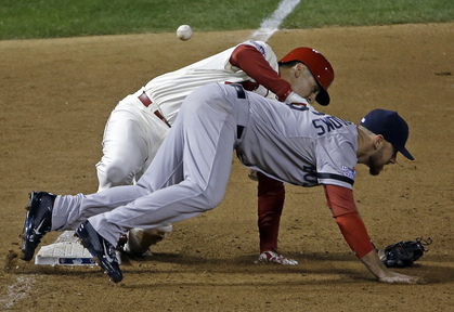 St. Louis Cardinals’ Allen Craig gets tangled with Boston Red Sox’s Will Middlebrooks during the ninth inning Saturday night in St. Louis. Middlebrooks was called for obstruction on the play and Craig went in to score the winning run. The Cardinals won 5-4 to take a 2-1 lead in the series.