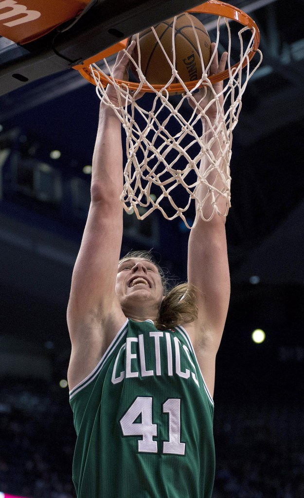 Boston’s Kelly Olynyk slam-dunks against the Toronto Raptors during the first half of a preseason game in Toronto on Wednesday.